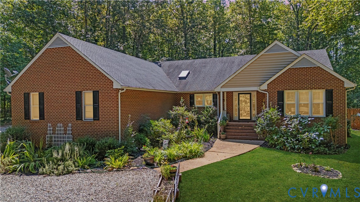 1937 Woodberry Mill Road Powhatan, VA 23139 - Photo 1 of 60 a front view of a house with a garden