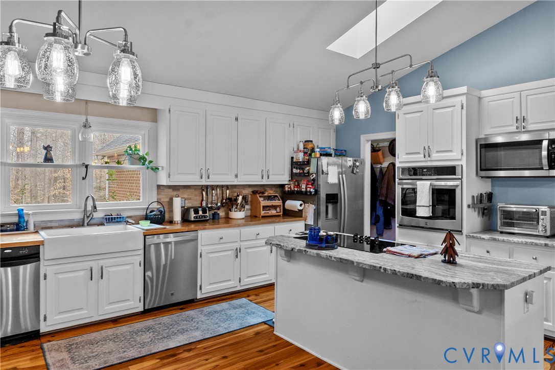1937 Woodberry Mill Road Powhatan, VA 23139 - Photo 15 of 60 a kitchen with stainless steel appliances a sink stove and refrigerator