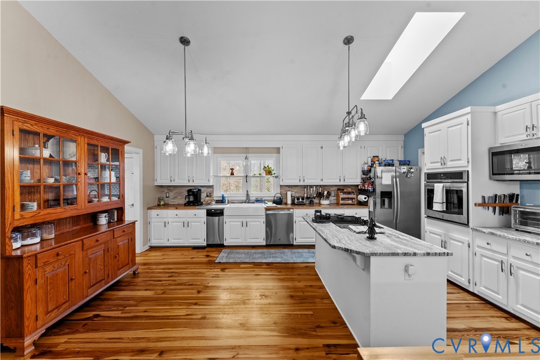 1937 Woodberry Mill Road Powhatan, VA 23139 - Photo 16 of 60 a kitchen with stainless steel appliances kitchen island granite countertop a stove and a sink