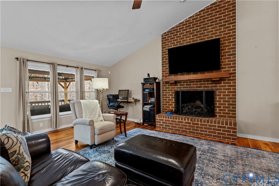 1937 Woodberry Mill Road Powhatan, VA 23139 - Photo 18 of 60 a living room with furniture a flat screen tv and a fireplace
