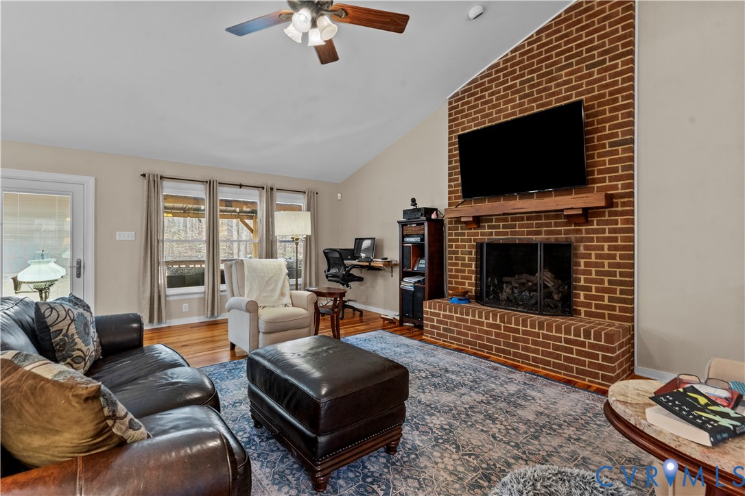 1937 Woodberry Mill Road Powhatan, VA 23139 - Photo 19 of 60 a living room with furniture a flat screen tv and a fireplace