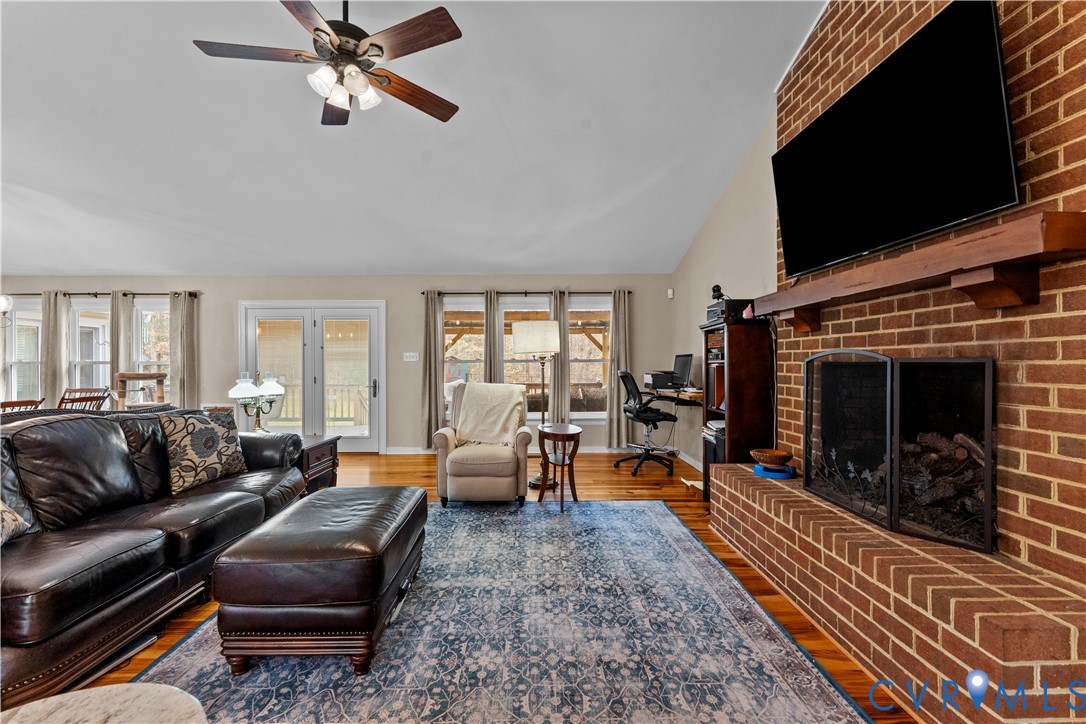 1937 Woodberry Mill Road Powhatan, VA 23139 - Photo 20 of 60 a living room with furniture a flat screen tv and a fireplace