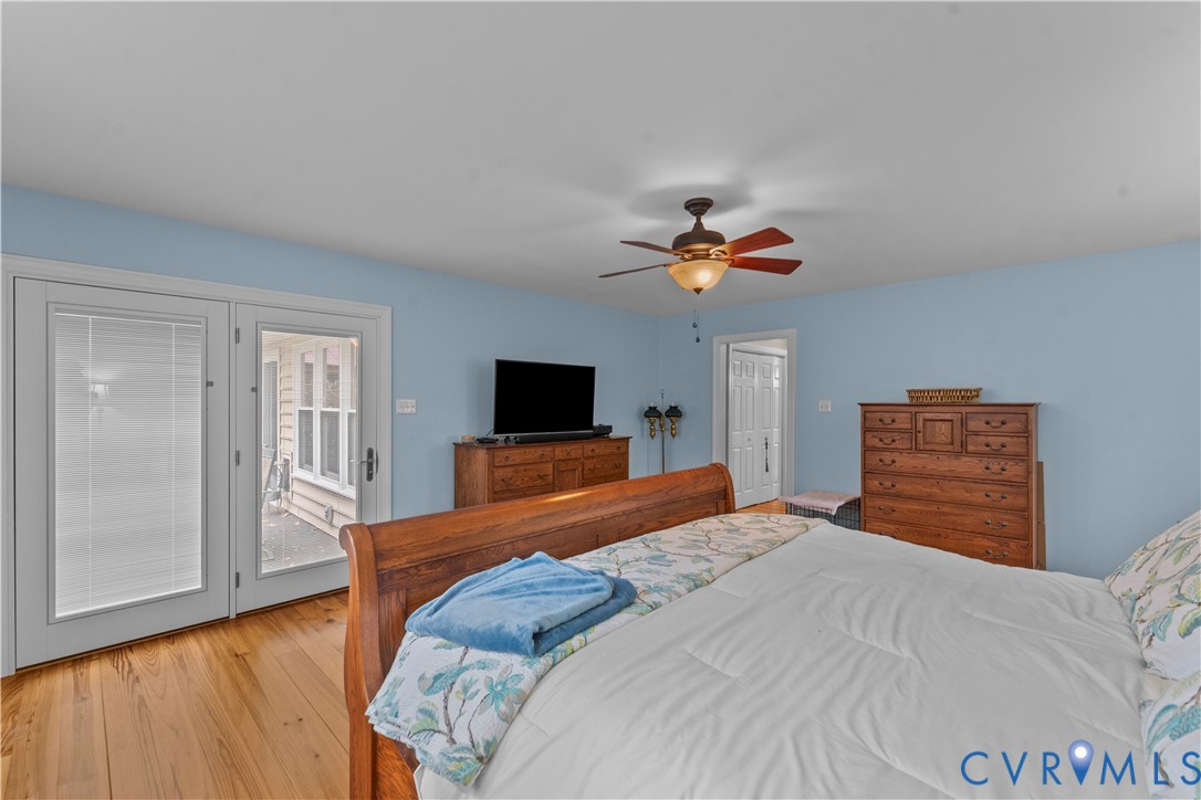 1937 Woodberry Mill Road Powhatan, VA 23139 - Photo 33 of 60 a bedroom with a large bed and a flat screen tv
