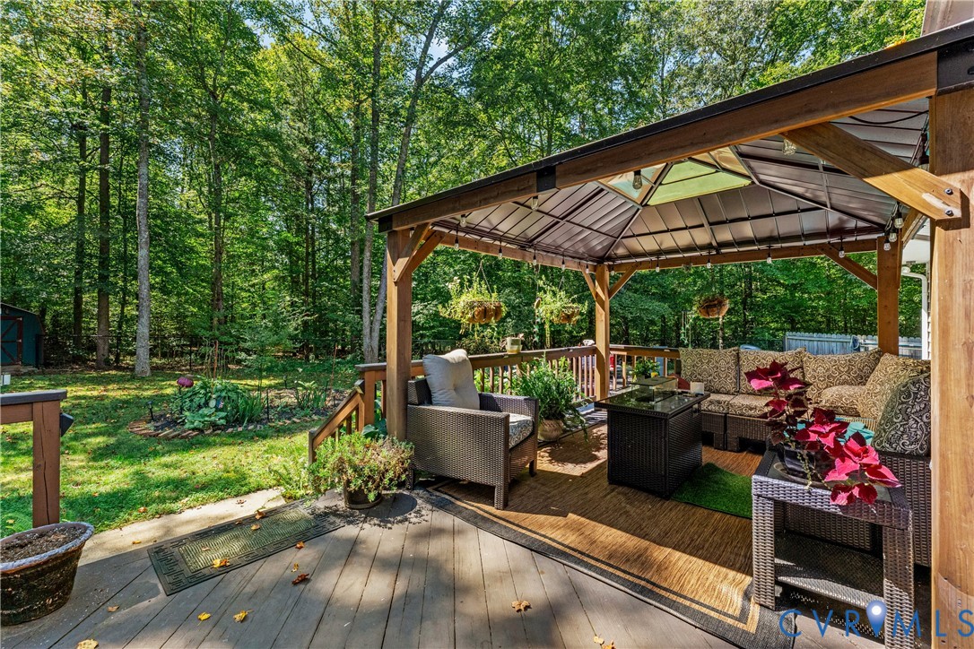 1937 Woodberry Mill Road Powhatan, VA 23139 - Photo 44 of 60 a view of a patio with a table chairs and a backyard