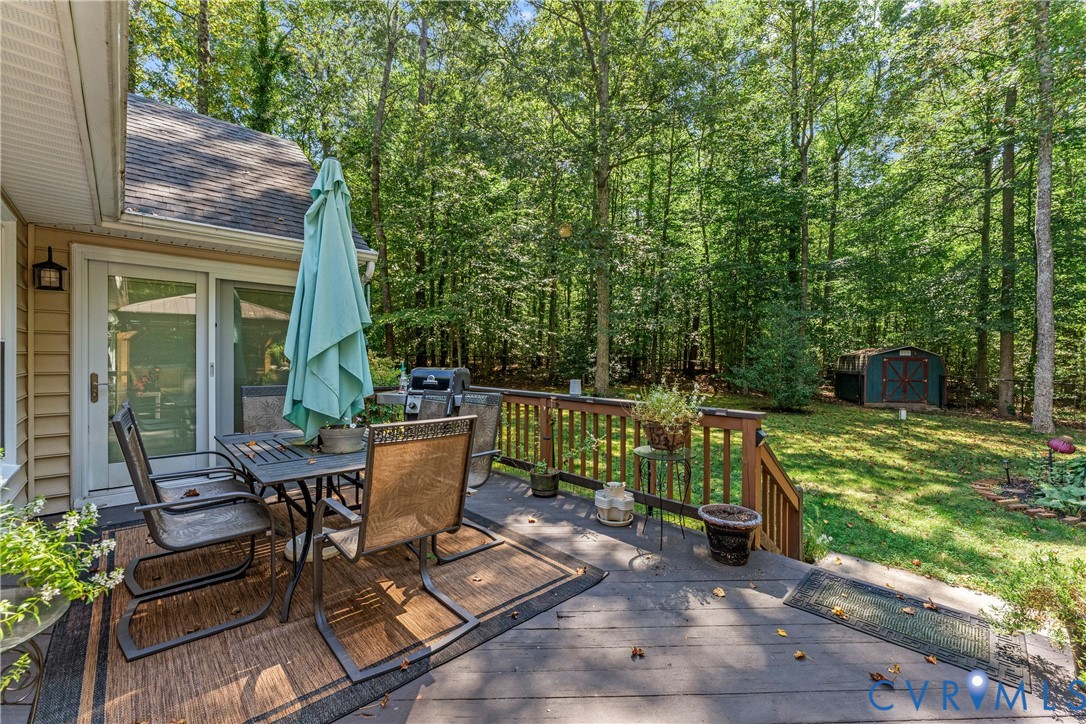 1937 Woodberry Mill Road Powhatan, VA 23139 - Photo 45 of 60 a view of a patio with table and chairs potted plants with wooden floor and fence