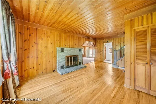 a view of a hallway with wooden floor and entryway