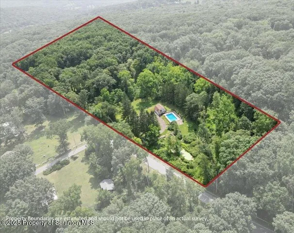 a view of a house with a yard and tree s