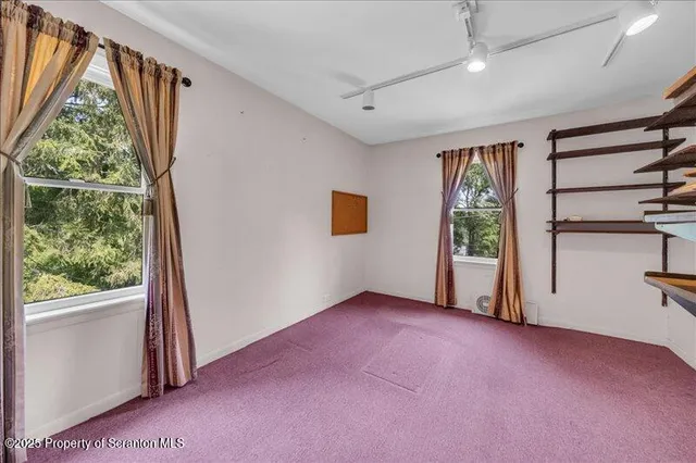 an aerial view of a house with a yard swimming pool and outdoor seating