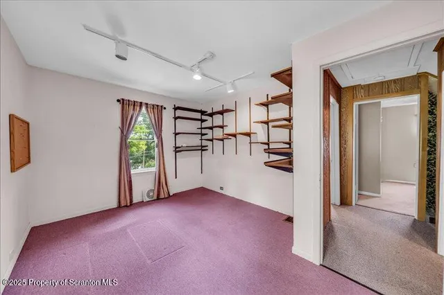 an aerial view of a house with garden space and street view