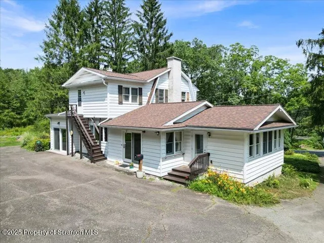 a kitchen with a table chairs sink and refrigerator