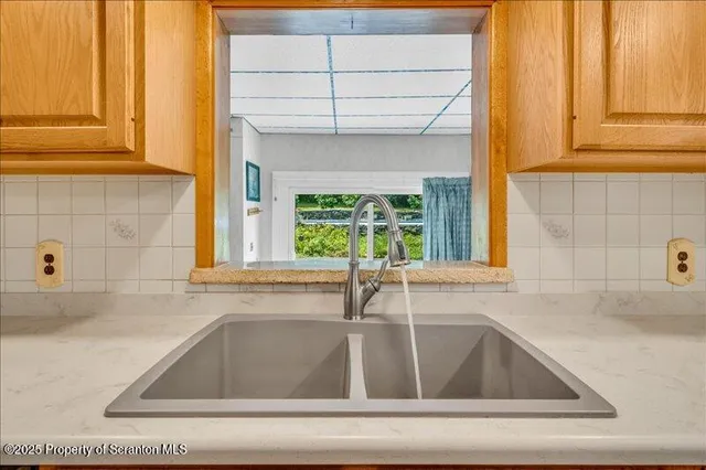 a view of a hallway with wooden walls