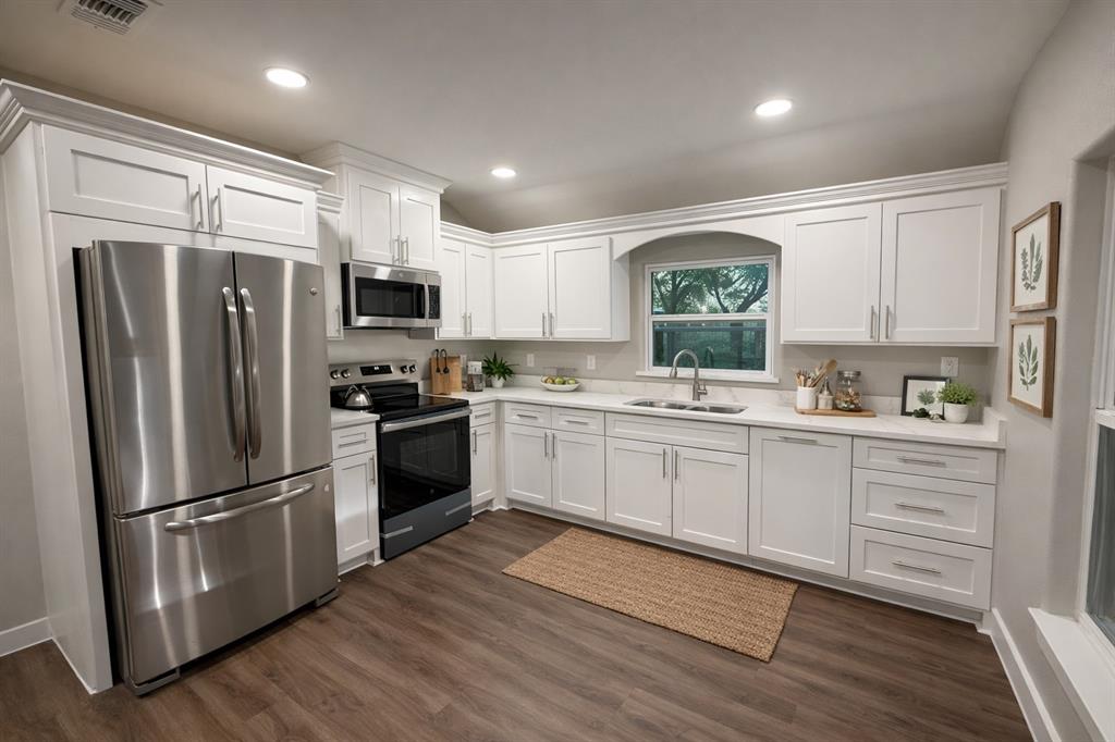 211 Crockett Street Rice, TX 75155 - Photo 3 of 12 a kitchen with stainless steel appliances a refrigerator sink and microwave