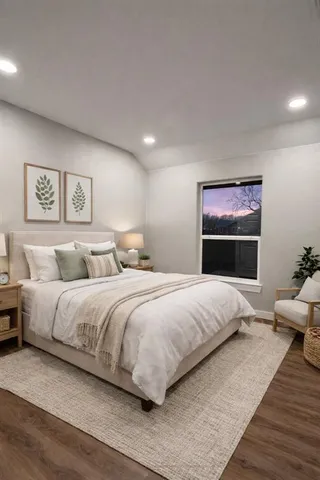 a bedroom with a large bed and a couch