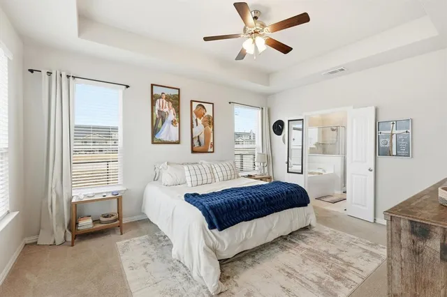 a spacious bedroom with a bed and a window