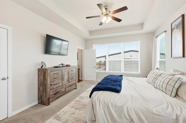 a spacious bedroom with a large bed and a flat screen tv