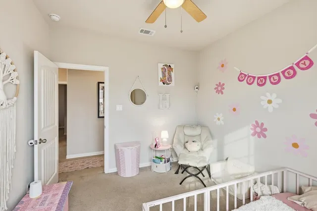 a bedroom with furniture and a chandelier fan