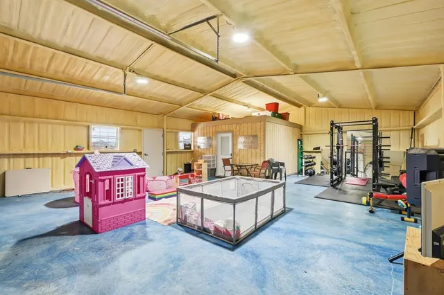 a spacious bedroom with a bed and a table