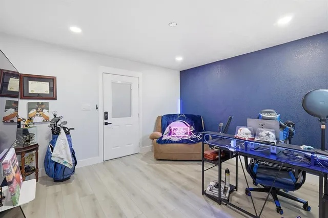 a living room with furniture a flat screen tv and a window