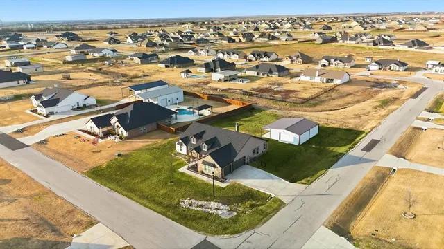 an aerial view of residential houses with outdoor space