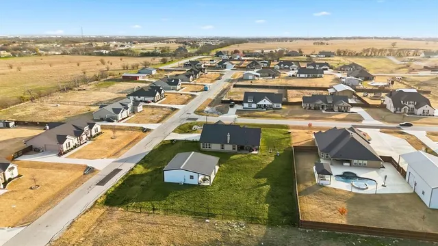 an aerial view of residential houses with outdoor space