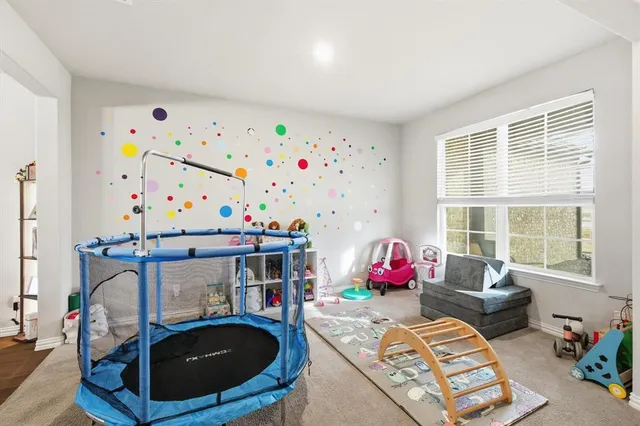 a living room with furniture toys and a window