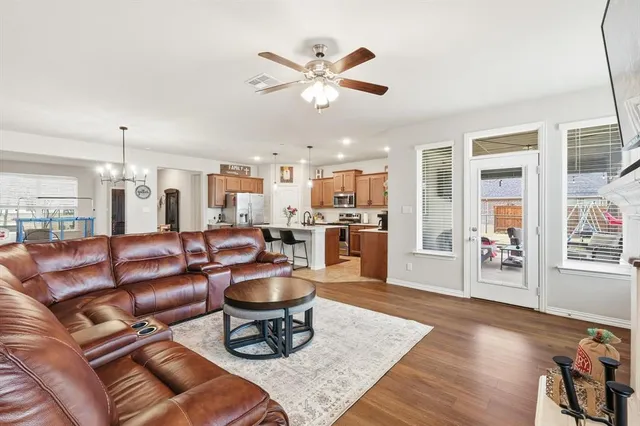 a living room with furniture and kitchen view