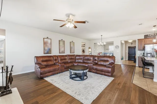 a living room with a couch and wooden floor