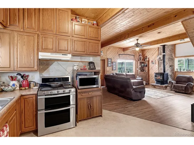 a kitchen with furniture a stove and a refrigerator