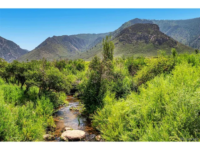 a view of a garden with a building in the background