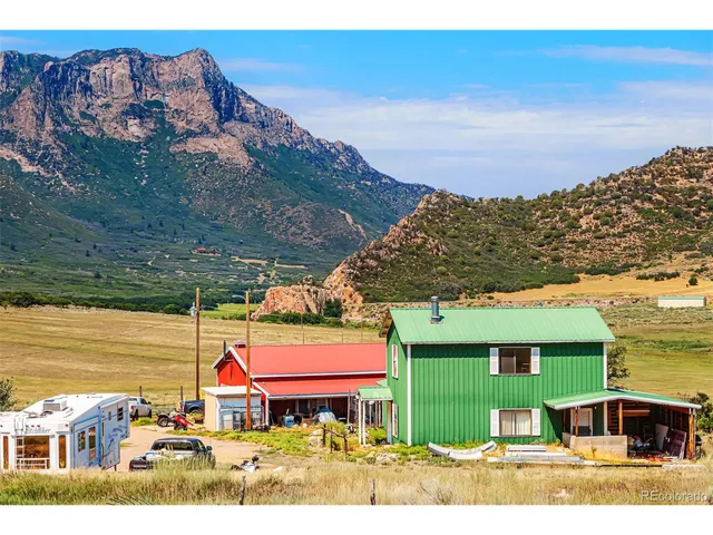 a living room with furniture a rug and a bookshelf
