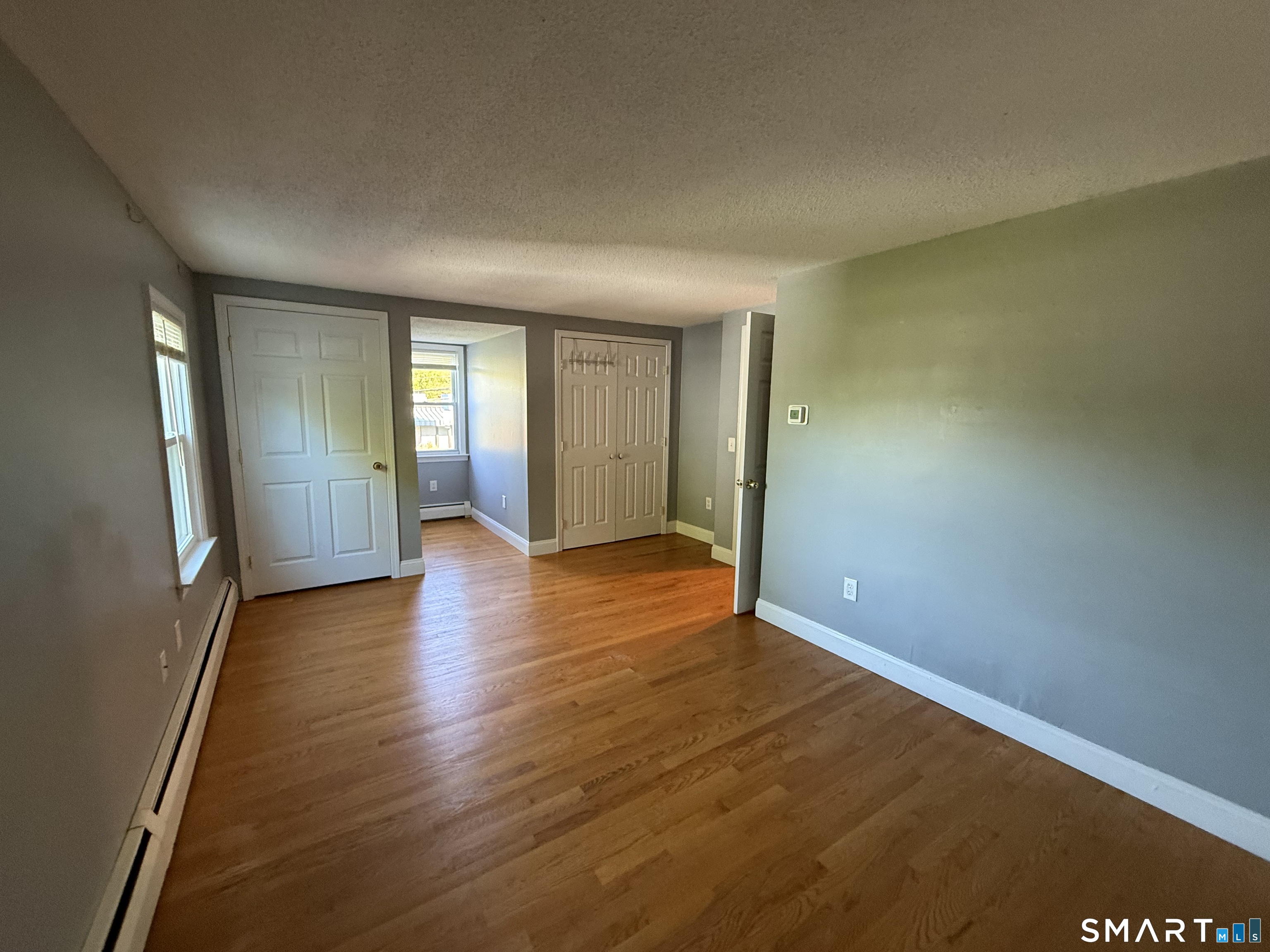 808 East Main Street Torrington, CT 06790 - Photo 34 of 40 an empty room with wooden floor and windows