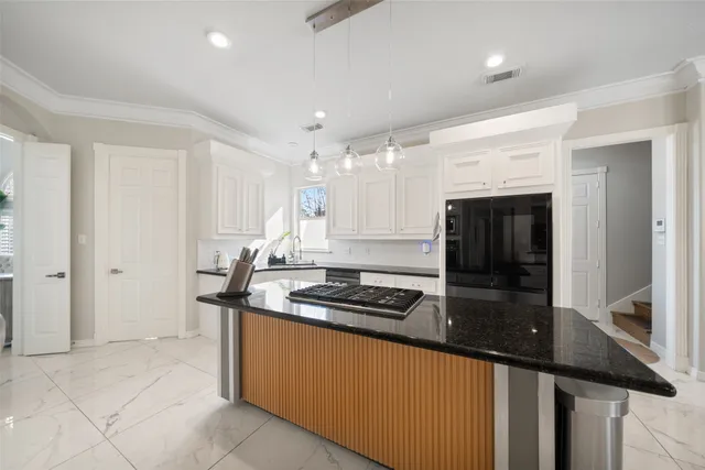 a kitchen with stainless steel appliances granite countertop a sink and cabinets