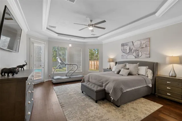 a bedroom with a bed a couch and dresser