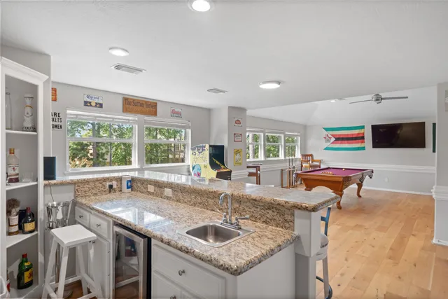 a kitchen with granite countertop a sink and a stove