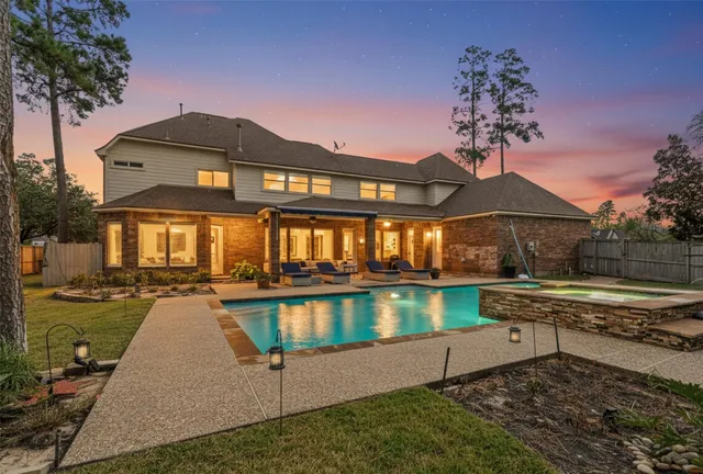 a front view of a house with swimming pool yard and outdoor seating