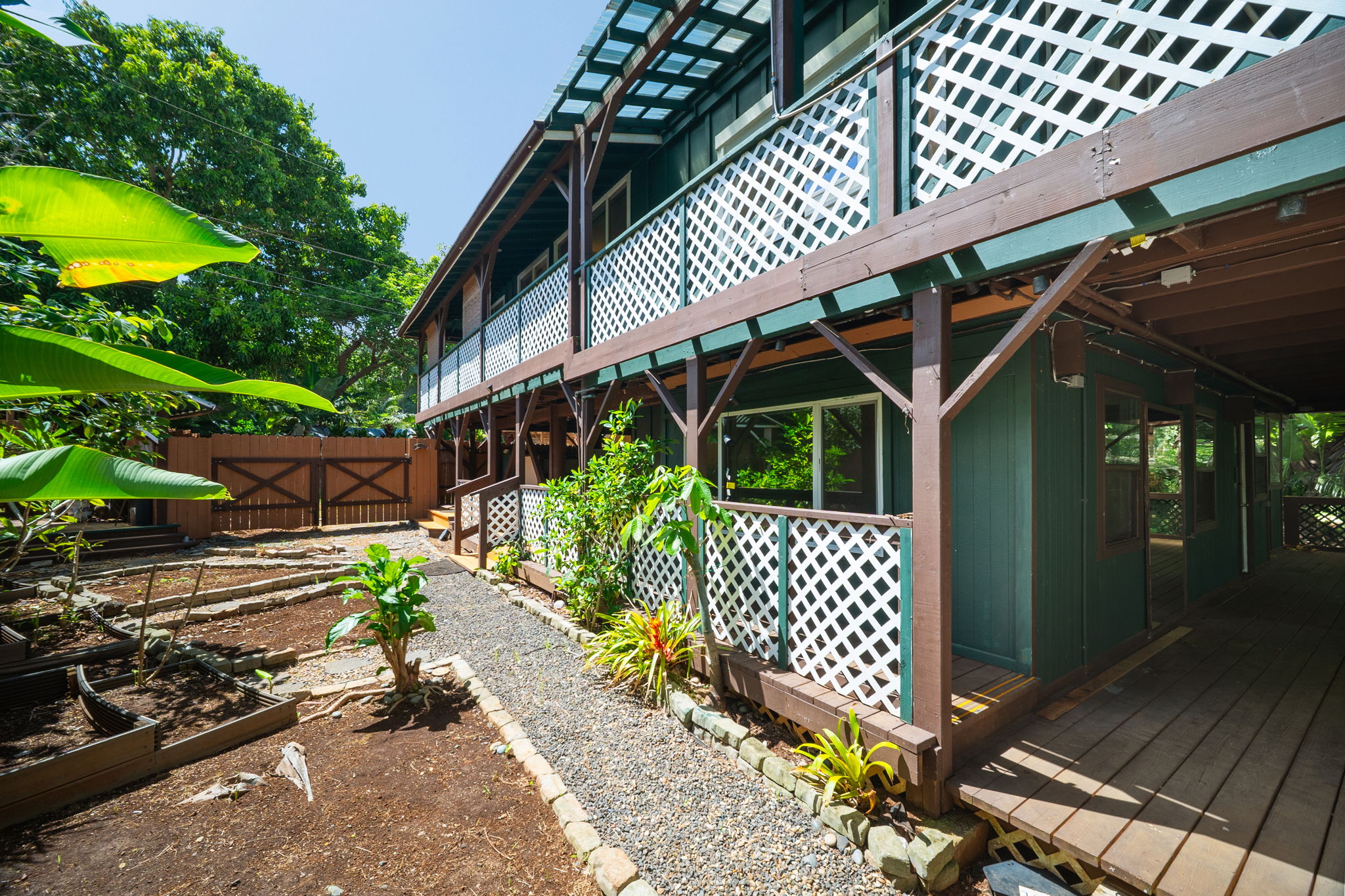 3590 Moloaa Road Kilauea, HI 96754 - Photo 24 of 29 a front view of a house with a garden