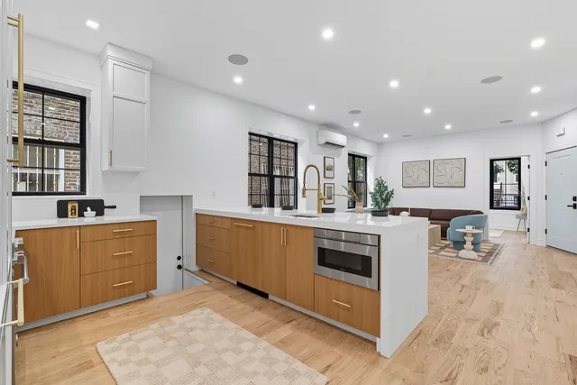 a living room with furniture a dining table and a wooden floor