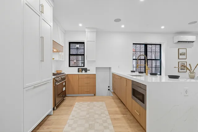 a kitchen with stainless steel appliances granite countertop a refrigerator and a stove top oven