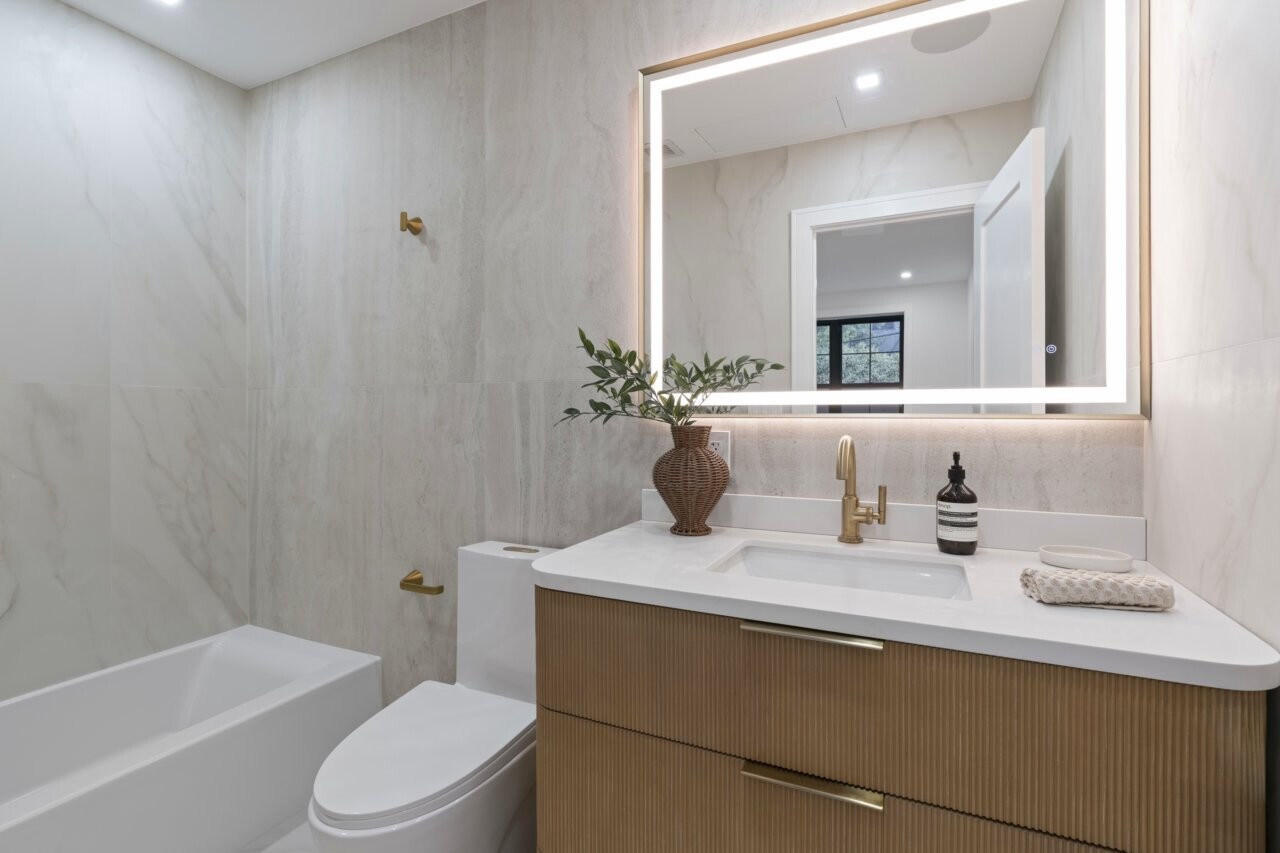 1109 Hancock Street Brooklyn, NY 11221 - Photo 25 of 30 a bathroom with a granite countertop sink a toilet and shower