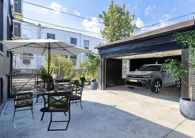 a view of a patio with couches potted plants and a table