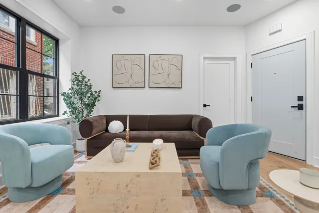 a living room with furniture a table and chair