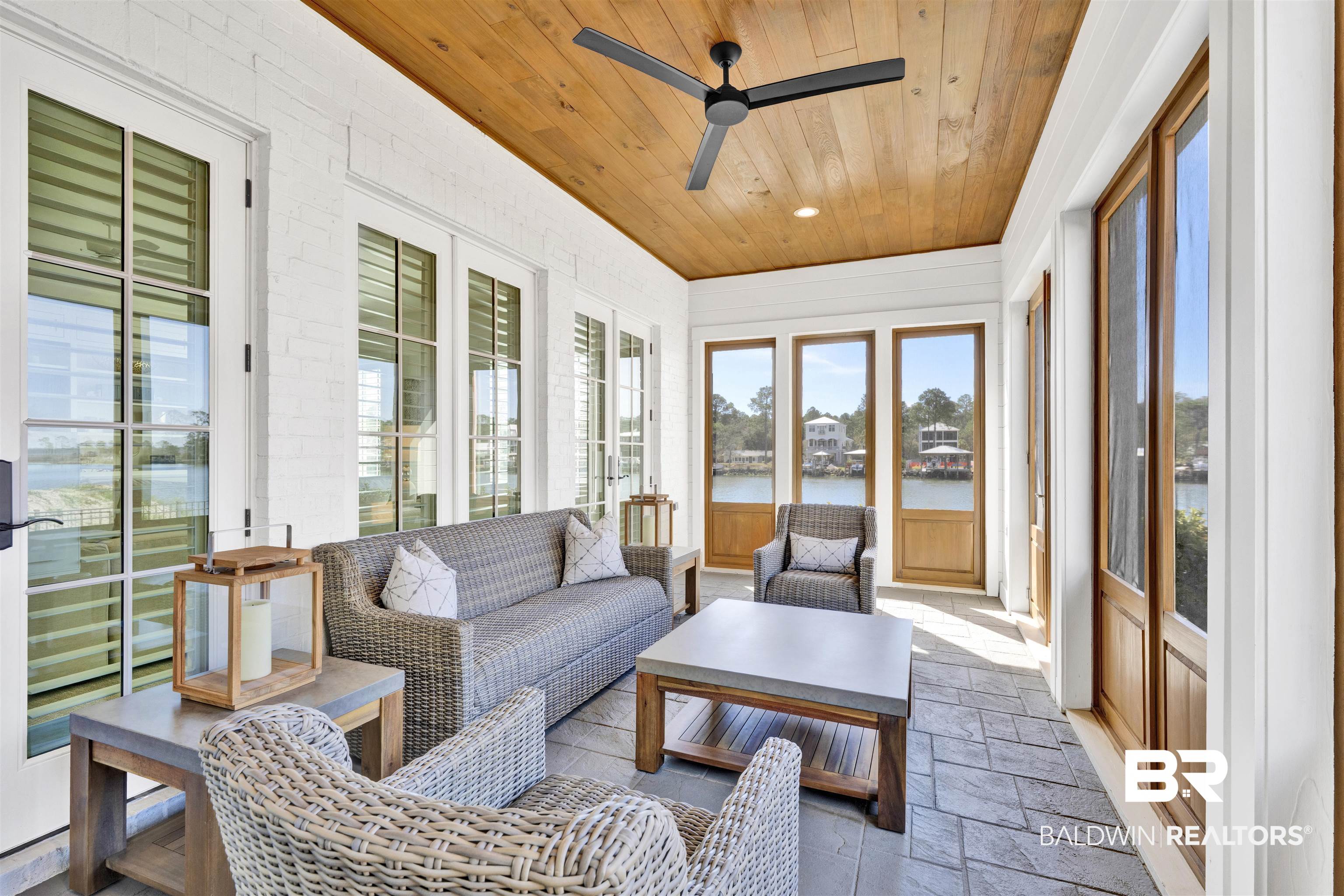 861 Inlet Circle Gulf Shores, AL 36542 - Photo 11 of 54 Sunroom / solarium featuring a water view, wooden ceiling, stone tile floors, french doors, and recessed lighting