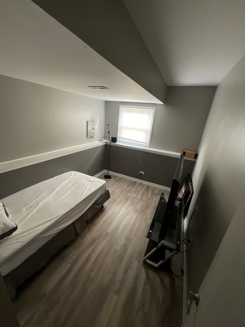 4033 Gregory Drive Zion, IL 60099 - Photo 11 of 16 a bedroom with a bed and window