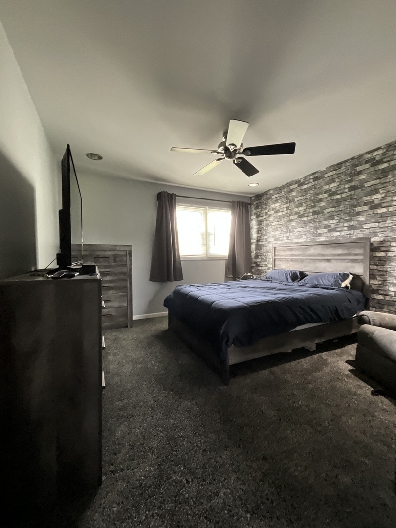 4033 Gregory Drive Zion, IL 60099 - Photo 5 of 16 a living room with furniture a ceiling fan and a rug