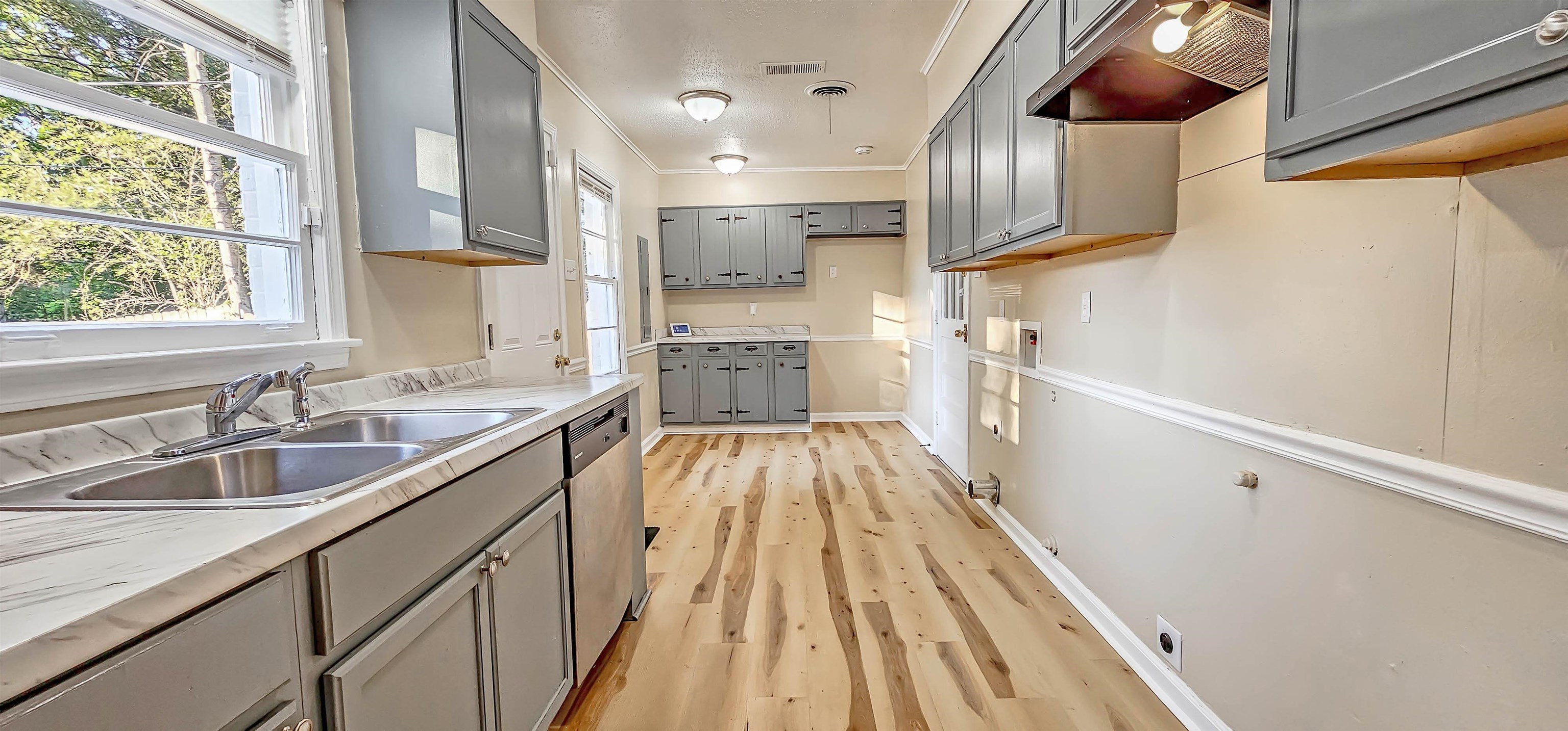 4420 Helene Road Memphis, TN 38117 - Photo 2 of 22 a view of a kitchen with a sink and dishwasher with wooden floor