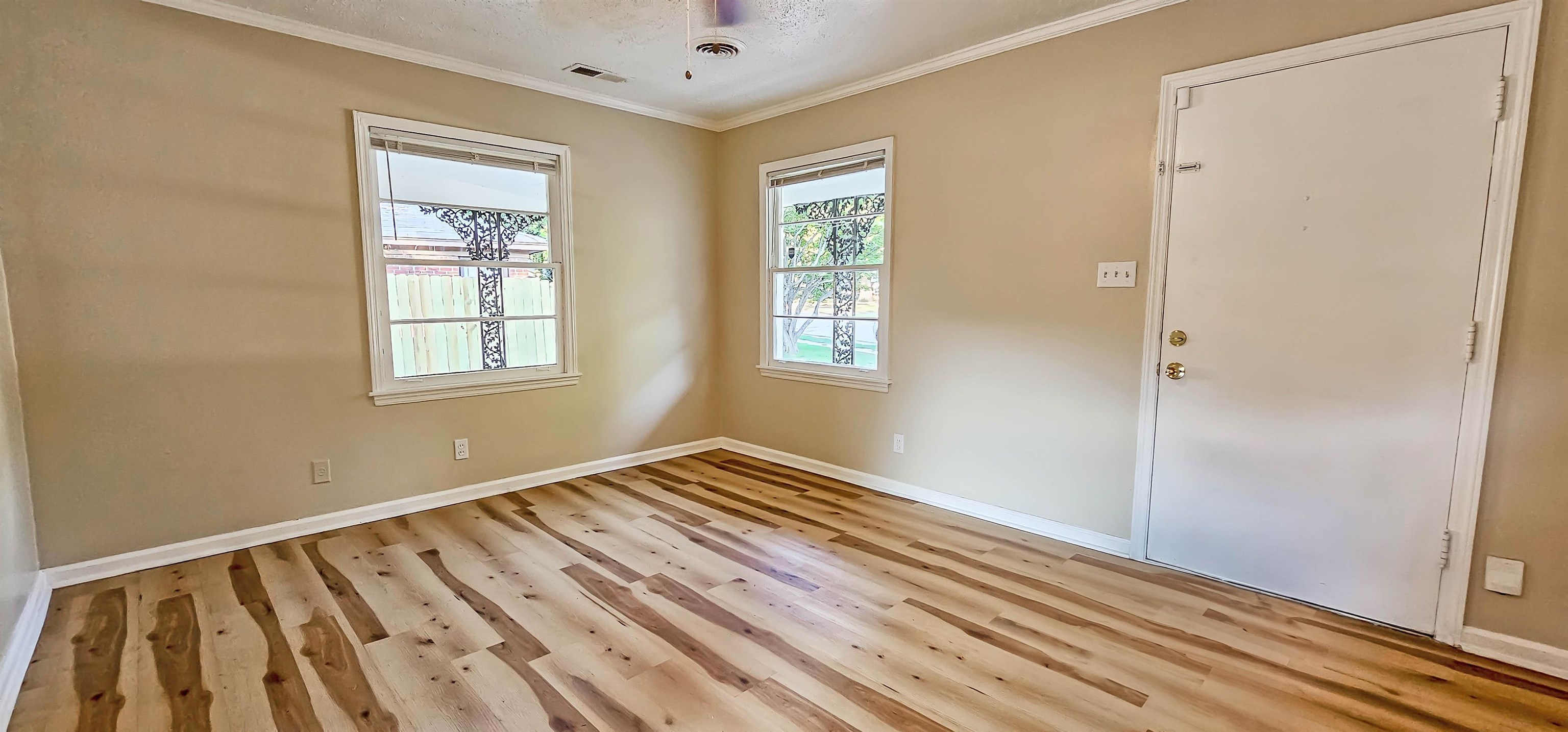 4420 Helene Road Memphis, TN 38117 - Photo 6 of 22 a view of an empty room with wooden floor and a window