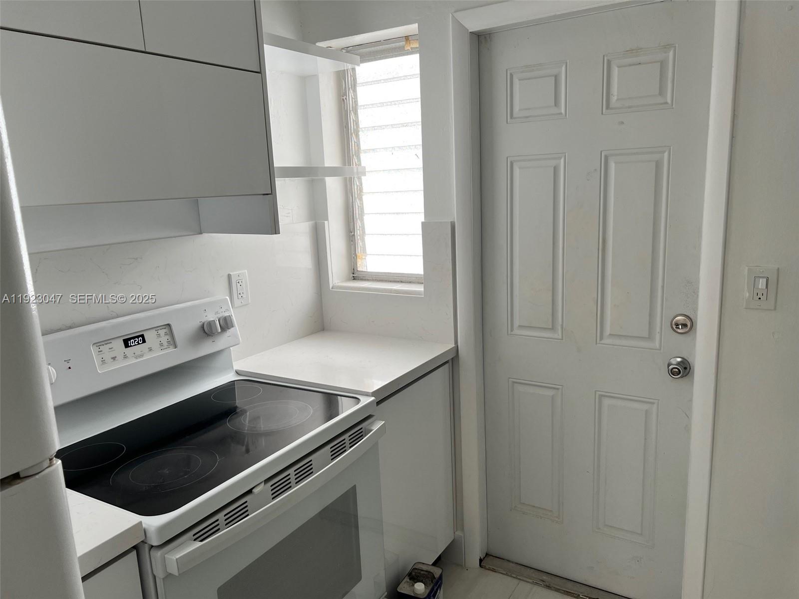 944 Meridian Avenue, Unit 10 Miami Beach, FL 33139 - Photo 12 of 15 a utility room with dryer and washer