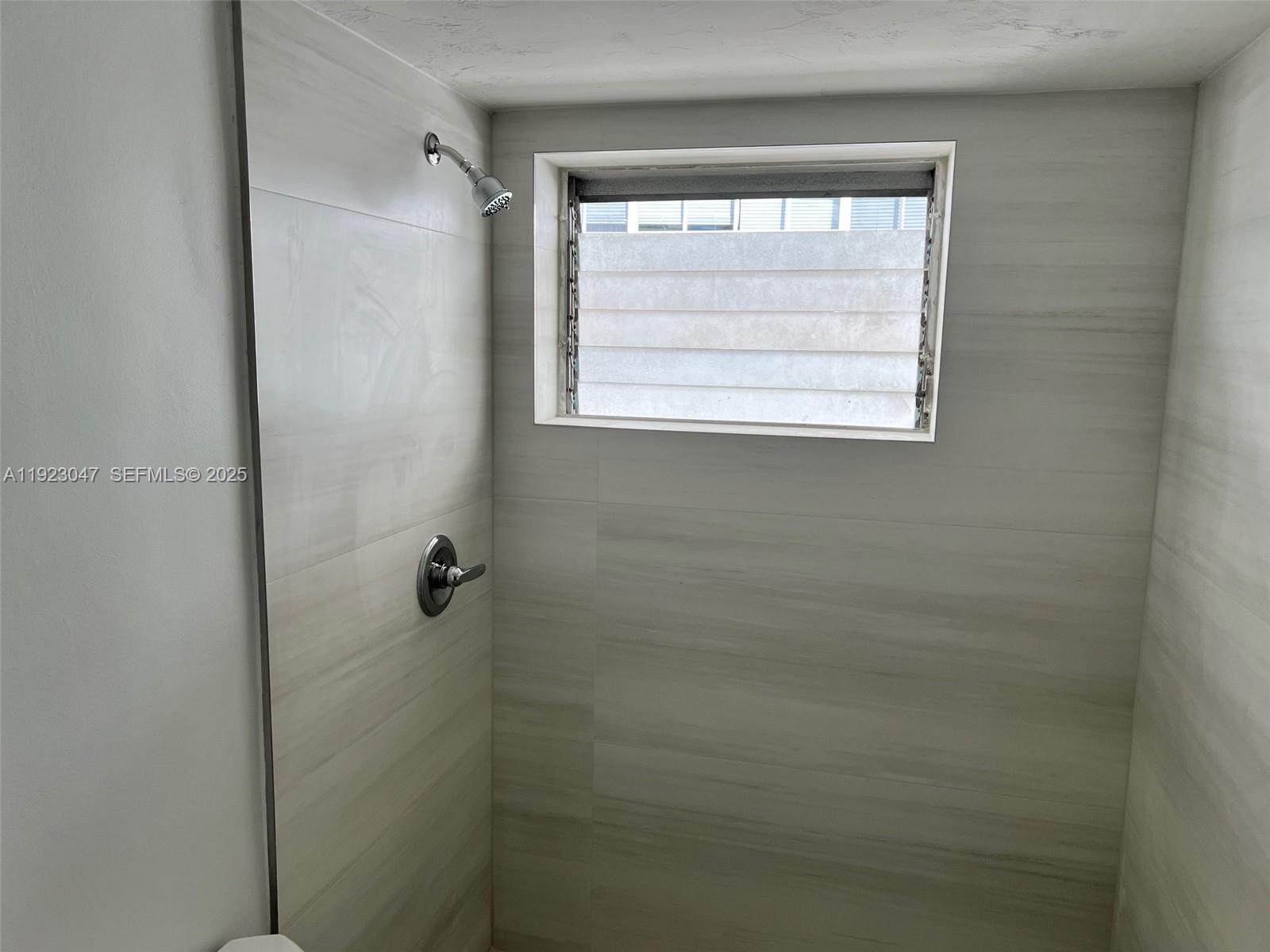 944 Meridian Avenue, Unit 10 Miami Beach, FL 33139 - Photo 4 of 15 a bathroom with a window