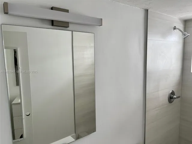 a bathroom with a glass shower door