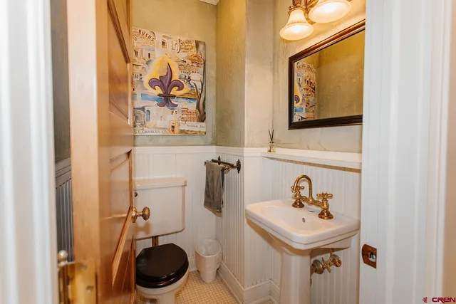 a bathroom with a sink and mirror with toilet